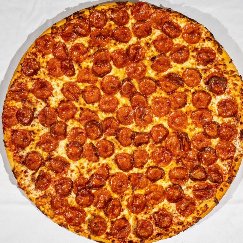 A large, round Bear's Den Pizzeria pepperoni pizza with a golden crust and melted cheese.